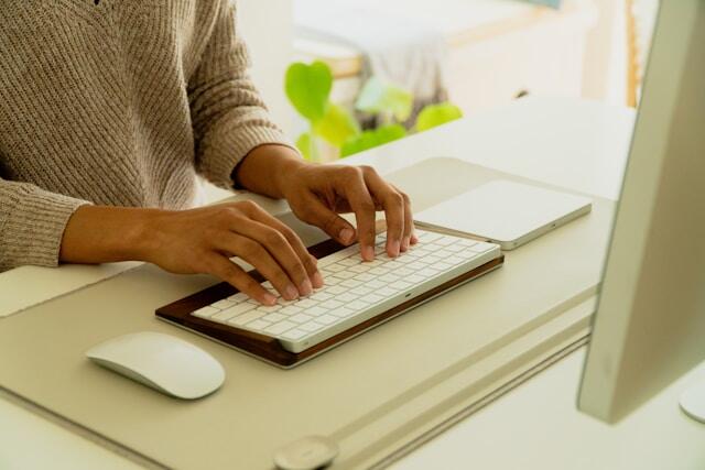 Person writing or typing on a computer