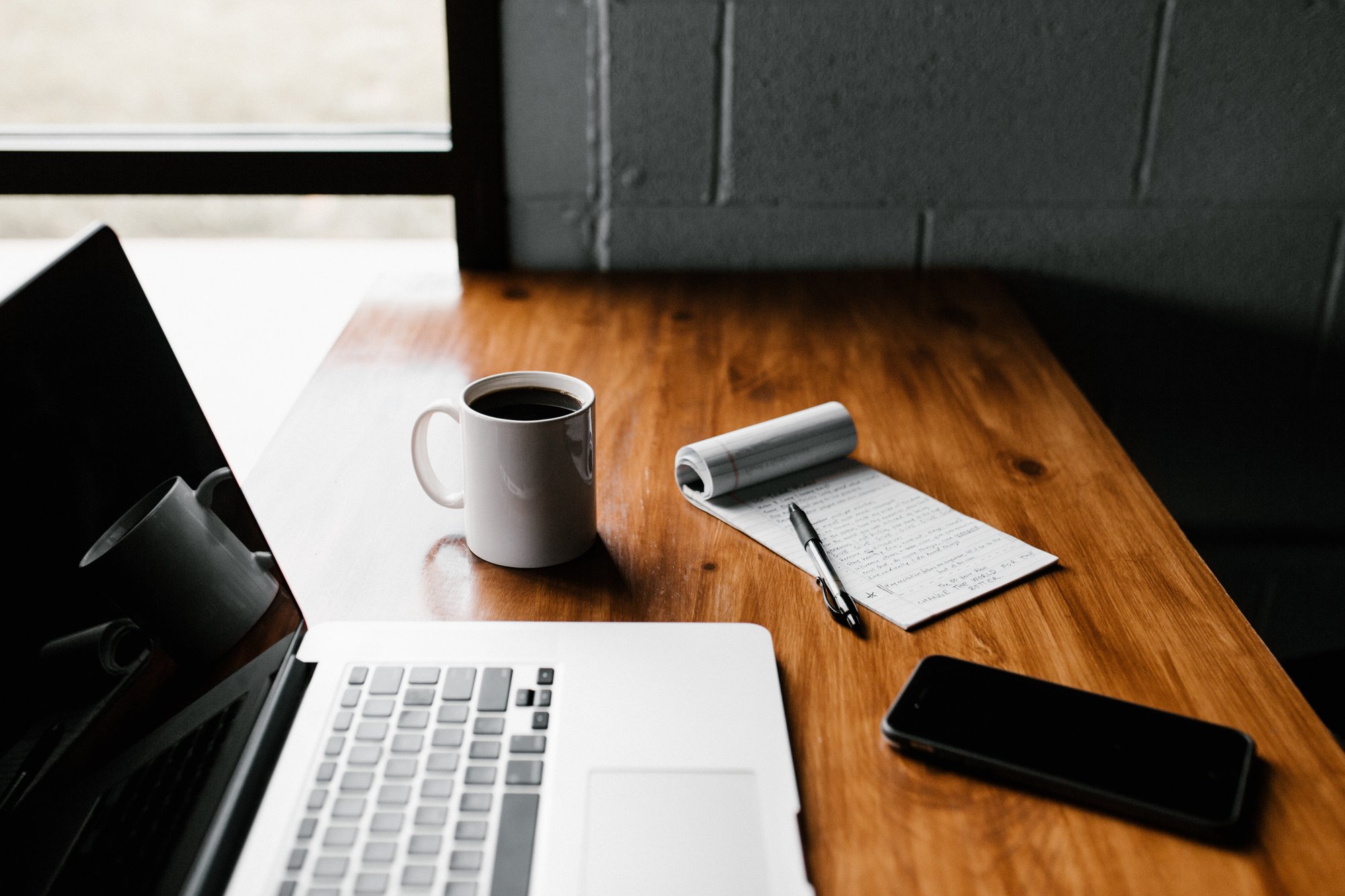 laptop, phone, coffee mug, notepad