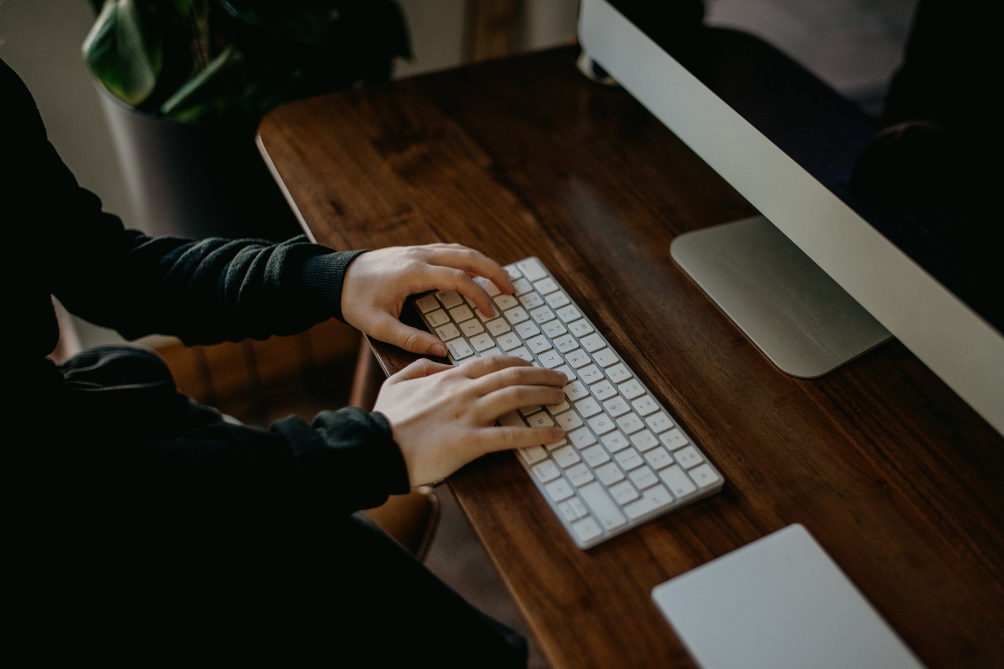 man writing on a desktop