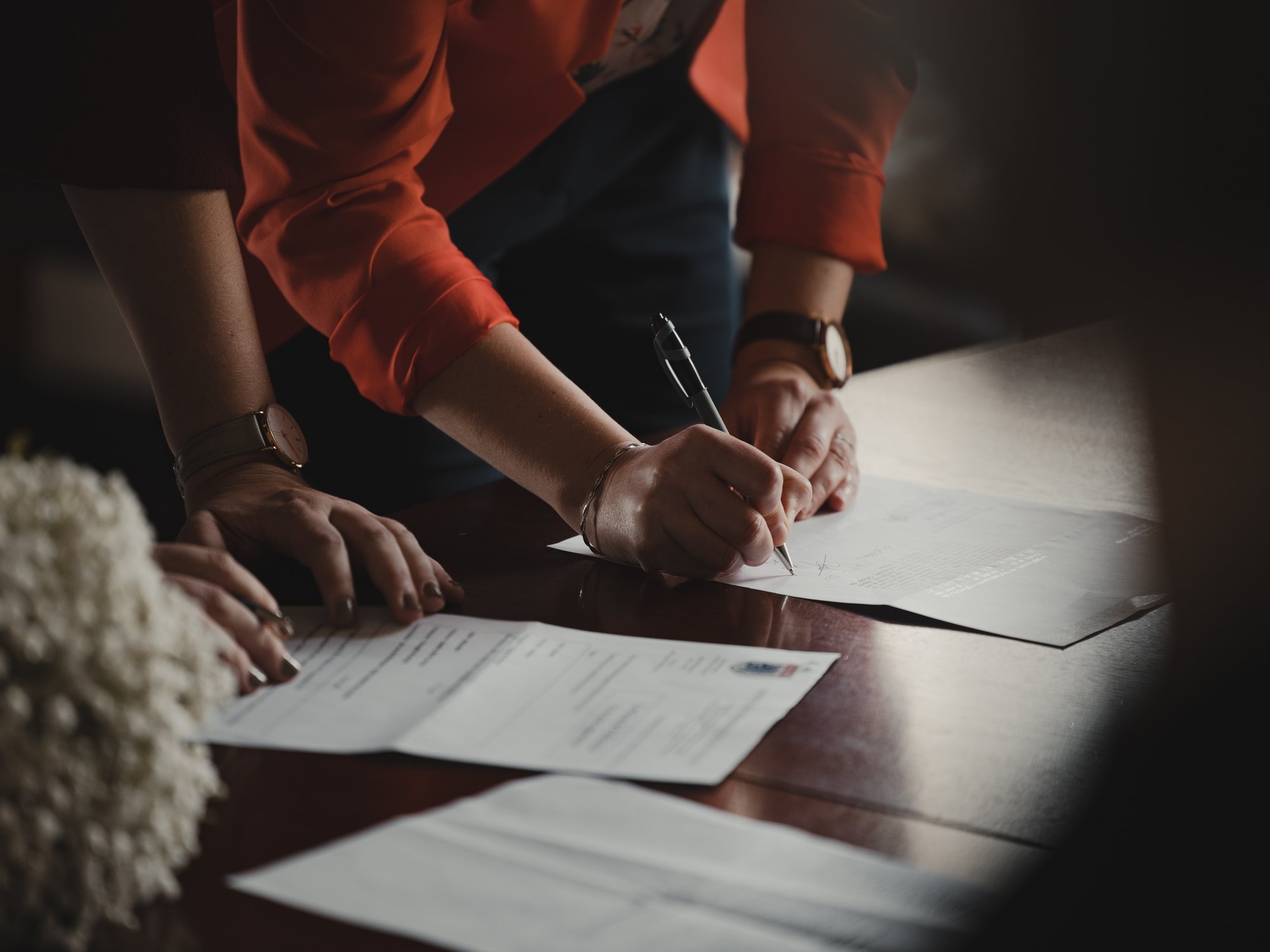 people signing a document